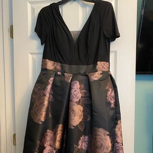 Black top with purple flowers on bottom. Cocktail dress, size 12.